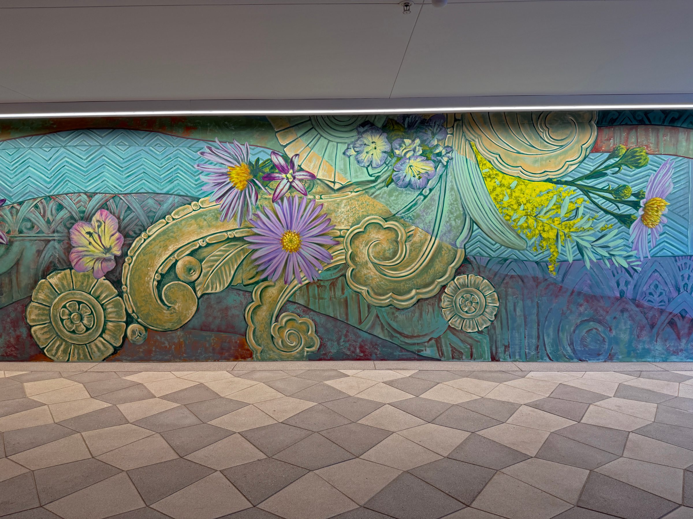 Section of the "Flourishing Structures" mural at Bloom on Third with lavender asters and cream scrollwork over teal waves