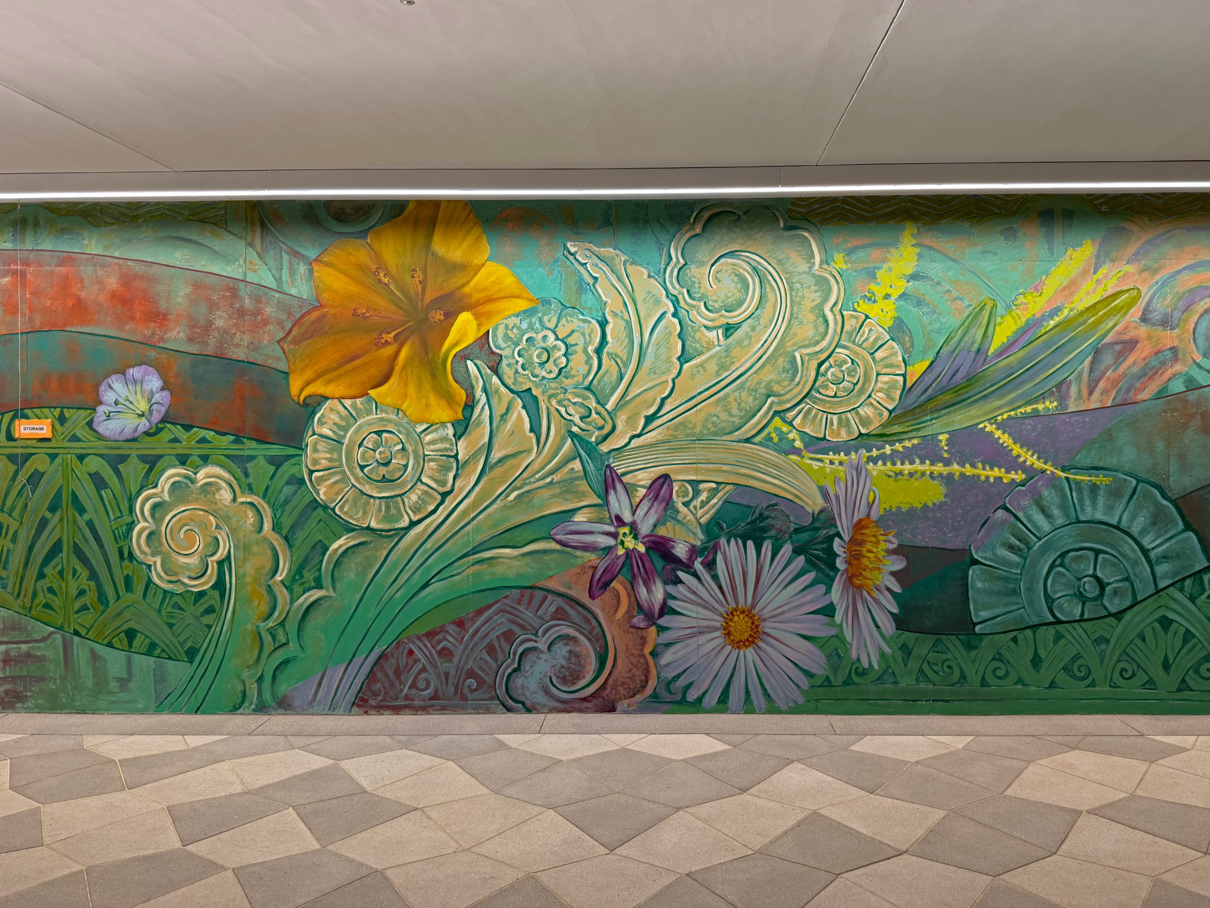 Section of the "Flourishing Structures" mural at Bloom on Third with an orange poppy, white daisies and gold scrollwork on green and teal