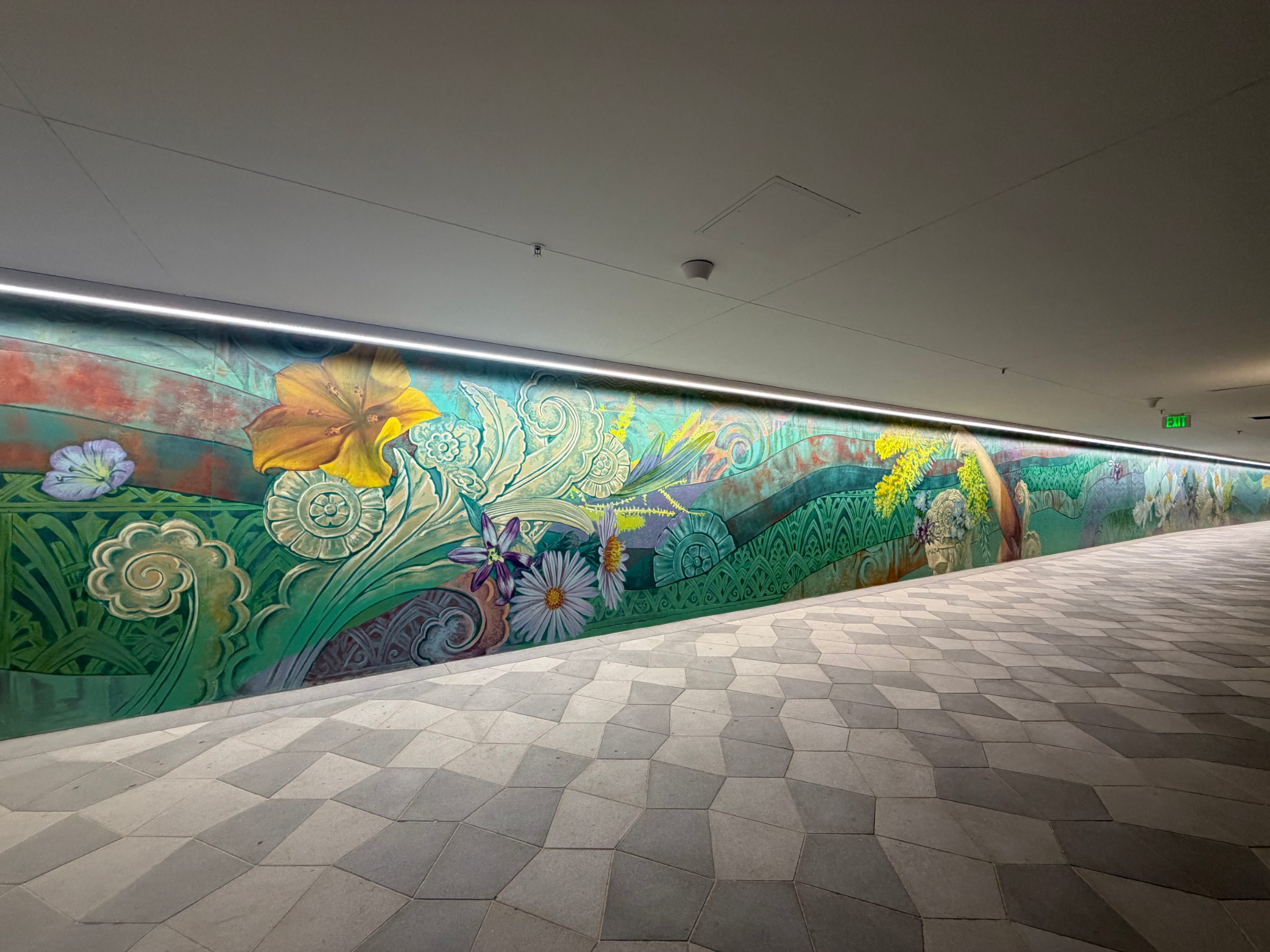 West flourishes section of the "Flourishing Structures" mural at Bloom on Third, seen at an angle along the paseo